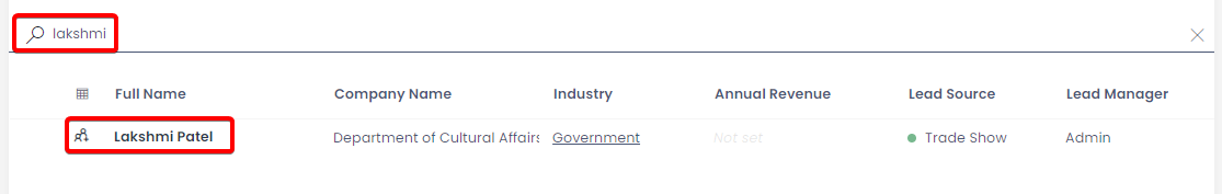 A screenshot of a user who has searched the leads table for &quot;Lakshmi&quot;. The data table now presents only one item in the table: a lead whose full name is &quot;Lakshmi Patel&quot;. The screenshot is annotated with two red boxes. The first annotation indicates the location of the search bar and the fact that the user has typed the word &quot;Lakshmi&quot; into the search bar. The second red box annotation indicates which column produced a result &quot;Full Name&quot; and indicates that the item row was returned because this column contained the name &quot;Lakshmi&quot;.